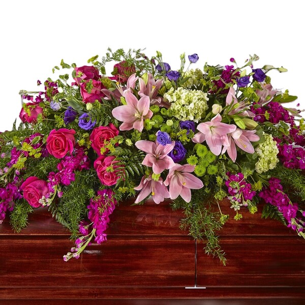 Radiant Tribute Casket Spray from Clifford's where roses are our specialty
